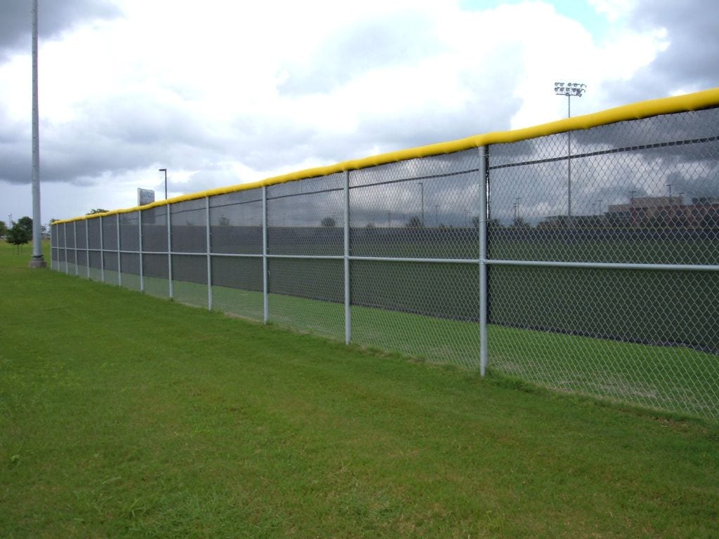 Baseball field chain link fencing with safety cap