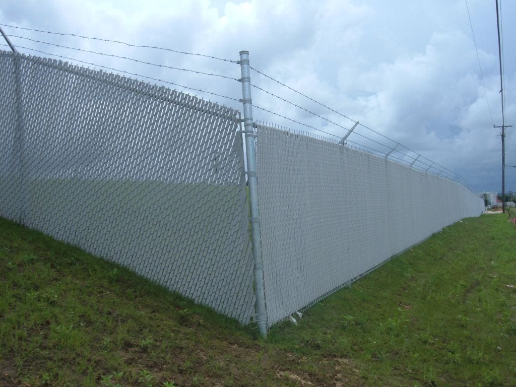 Commercial chain link fence with privacy slats