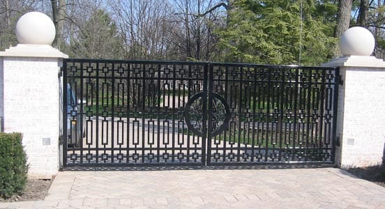 Iron estate driveway gate with brick pillars