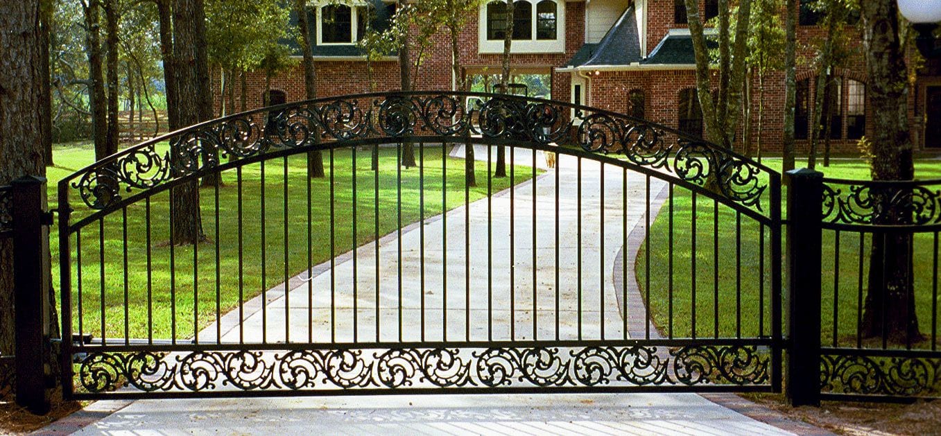 Wrought iron driveway gate with custom scrollwork