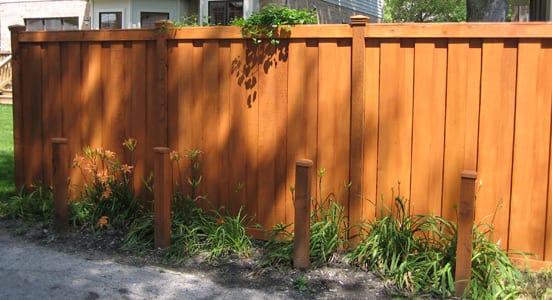 Stained board-on-board wood privacy fence