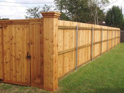 Cedar privacy fence with capped columns and walk gate